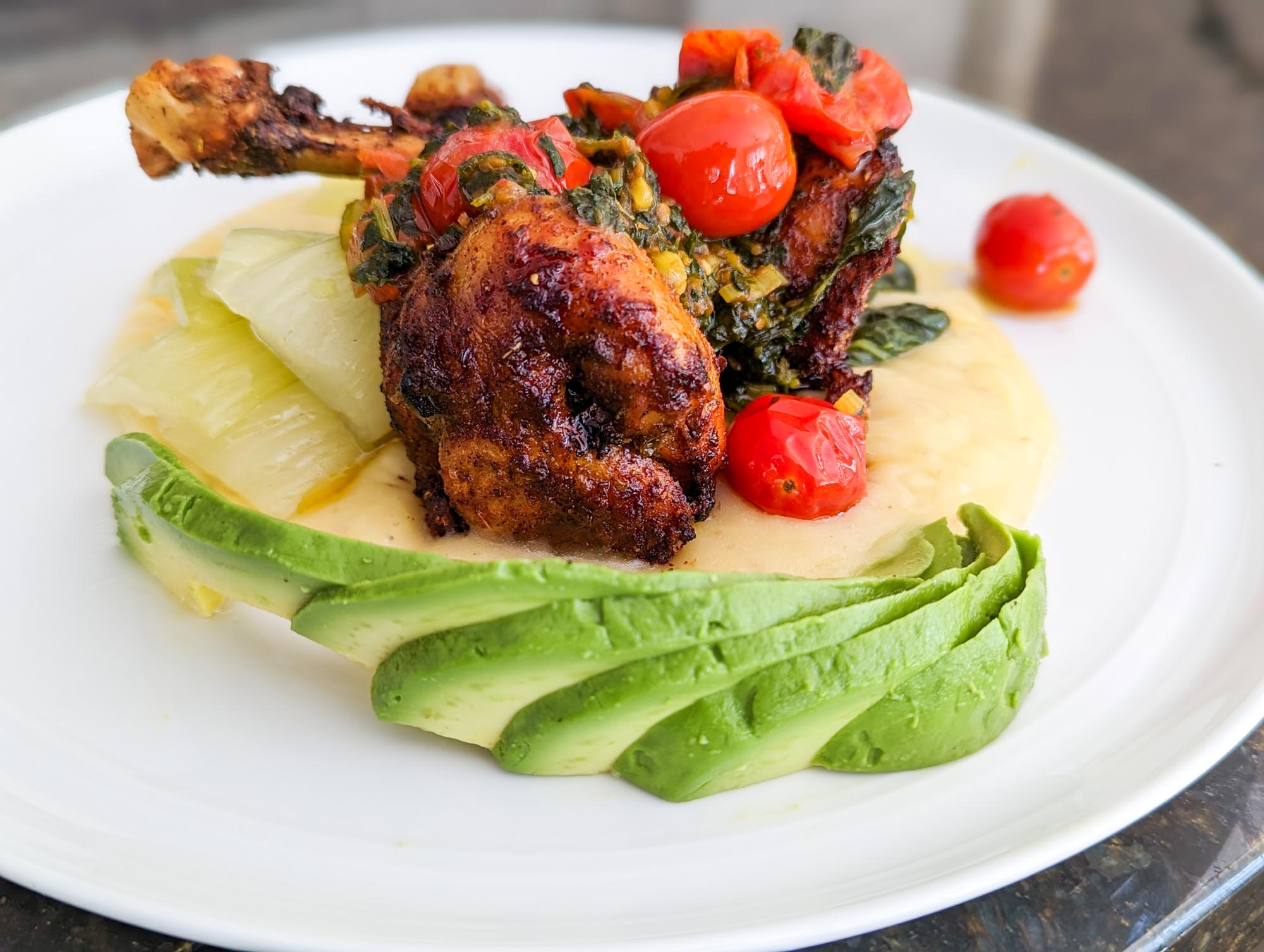 Roasted chicken plate with avocado and tomatoes